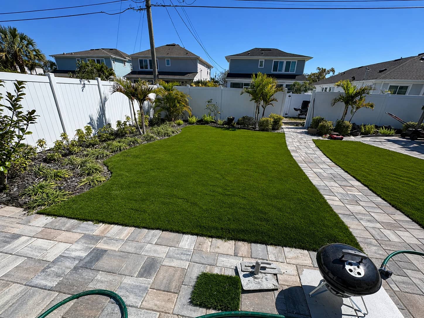 After photo of an artificial turf installation with fresh turf installed in the yard.